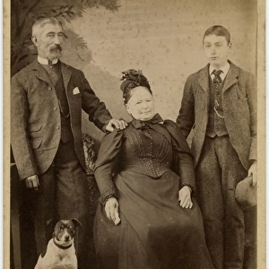 Studio portrait, family of three with terrier dog