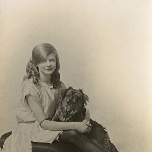 Studio portrait, girl with pug dog