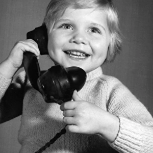 Studio portrait, little boy on the phone