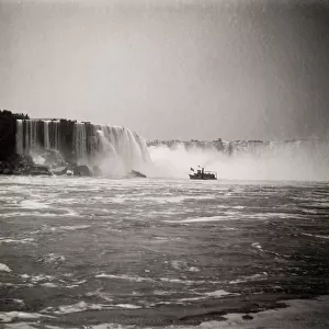 Tourist boats, spray of Niagara Falls, waterfall Canada