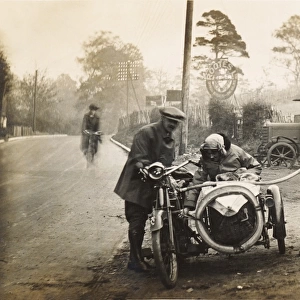 Veteran 1910 motorcycle & sidecar refuelling at a garage