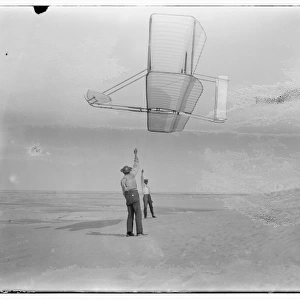 Side view of Dan Tate, left, and Wilbur, right, flying the 1
