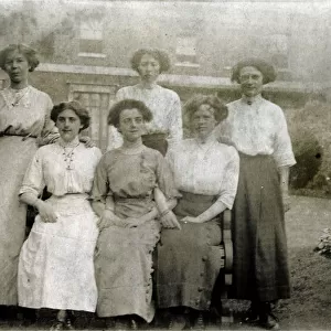 Five women pose for a group photograph in the garden