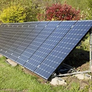 Array of solar PV photovolataic panels mounted on steel frame in field - Cotswolds UK