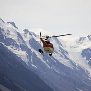 New Zeland - Helicopter flight over snow capped mountains and forested slopes in Aoraki - Mount Cook National Park. This spectacular wilderness area in South Island New Zealand has now been designated a World Heritage Site
