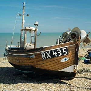 Trawler Boat. The beach at Dungeness looks like a dumping ground, but geologists are fascinated by the action of wind and tide, on this extreme corner of Kent. Fishermen are here because the sea near the shingle beach is exceptionally deep