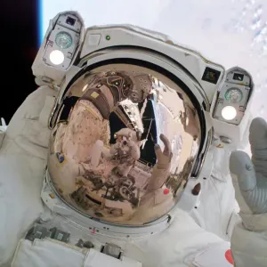 Return to Flight Spacewalk Print: Astronaut Soichi Noguchi waving Return to Flight Spacewalk Print: Astronaut Soichi Noguchi waving