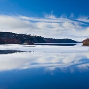 Scotland, Scottish Highlands, Loch Garry. Cloud formations reflected upon the mirror like face of Loch