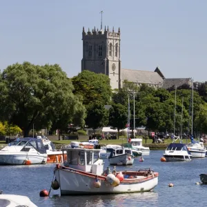 Christchurch Priory and pleasure boats on the River Stour, Dorset, England