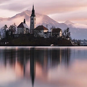 A church in the island in the middle of Bled lake at sunrise, Slovenia, Europe