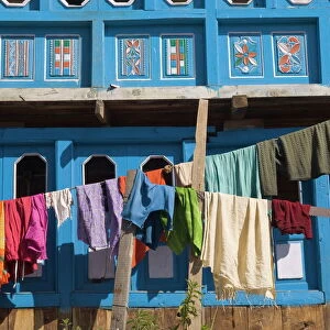 Close up of colourful laundry hanging in front of blue