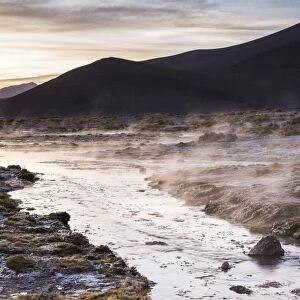 Geothermal river at sunrise at Chalviri Salt Flats (Salar de Chalviri), Altiplano of Bolivia