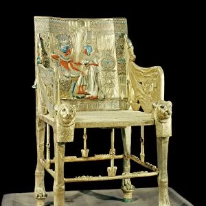 The gilt throne, the back decorated with a scene showing the royal couple