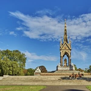 Three heavy horses are ridden past The Albert Memorial, Kensington Gardens, Hyde Park