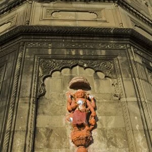 Hindu temple god on wall on banks of the Narmada River