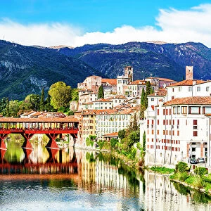 Historic buildings and Ponte Degli Alpini reflected in river Brenta, Bassano Del Grappa, Vicenza province, Veneto, Italy, Europe