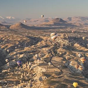 Hot air balloons rising into the dawn sky above Goreme, Cappadocia, Anatolia, Turkey, Asia Minor, Eurasia