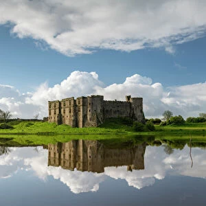The magnificent ruins of Carew Castle reflected in the Mill Pond in spring, Carew, Pembrokeshire, Wales, United Kingdom, Europe
