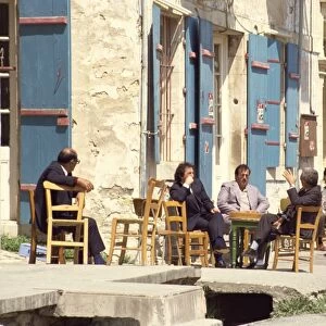 Men sitting outside on the pavement, putting the world to rights, one Sunday morning in Lefkara