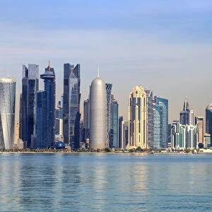 Modern city skyline of West Bay, across the calm waters of Doha Bay, from the Dhow Harbour