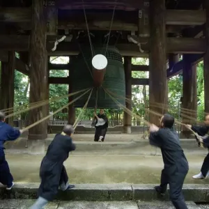 Monks pulling ropes of a large temple bell Print Monks pulling ropes of a large temple bell Print