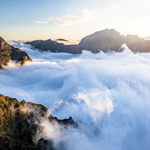 Mountain peaks emerging from clouds at sunset view from Pico Ruivo, Madeira, Portugal