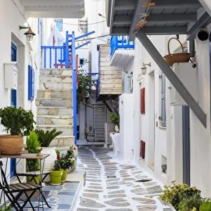 Narrow street, whitewashed buildings with blue paint work, flowers, Mykonos Town (Chora)