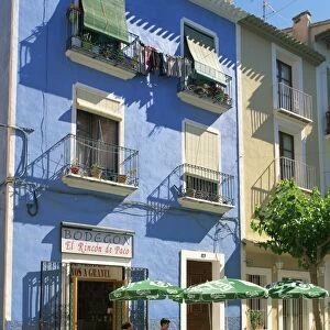 Pavement cafe in front of a blue painted building in Villajoyosa