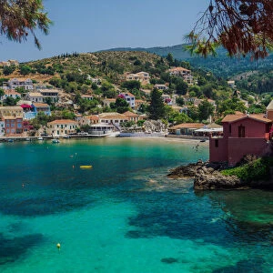 Sunny view of traditional Asos Village with low-rise houses by the sea in Kefalonia village, Kefalonia, Ionian Islands, Greek Islands, Greece, Europe