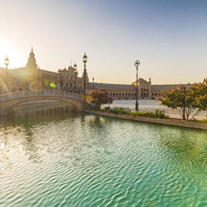 Sunrise over the decorated buildings and bridges along the canal, Plaza de Espana