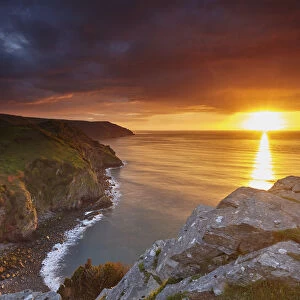 Sunset over coastal cliffs seen from the Valley of Rocks, Lynton, Exmoor National Park
