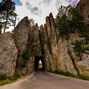Tiny road passing under a small mountain in the Black Hills of Keystone, South Dakota