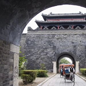 Tourist rickshaw at a city gate watch tower, Qufu City UNESCO World Heritage Site