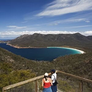 Tourists admiring the view of Wineglass Bay, Coles Bay, Freycinet Peninsula, Freycinet National Park, Tasmania, Australia