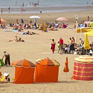 Typical color striped beach cabins, tourists, beach and sea, Trouville sur Mer, Normandy