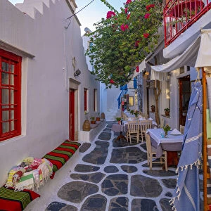 View of cafe in colourful narrow cobbled street, Mykonos Town, Mykonos, Cyclades Islands