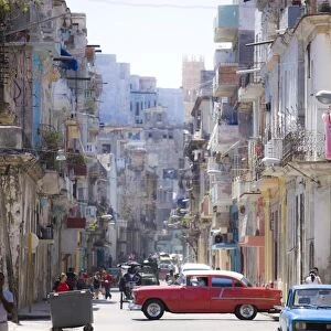 View along congested street in Havana Centro showing people walking along pavements