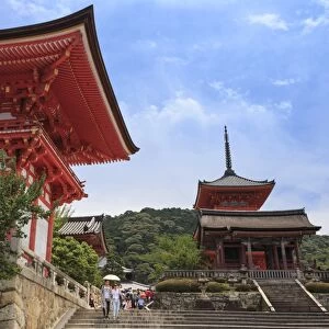 Visitors with sun umbrella in summer, vermillion temple entrance buildings, Kiyomizu-dera