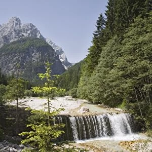 Waterfall over weir on River Velika Pisnca with crystal clear water