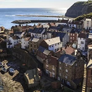 Winding alleys, fishing boats and sea, elevated view of village in summer, Staithes