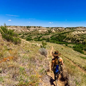 Woman hiking along The Petrified Forest Loop Trail inside Theodore Roosevelt National