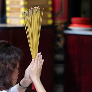 Worshipper burning incense sticks, Taoist temple, Phuoc An Hoi Quan Pagoda
