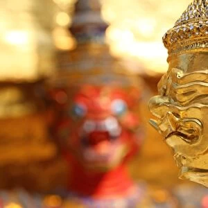 Golden Kinnara staue and Yaksha Demon at the Wat Phra Kaew Royal Palace complex in Bangkok