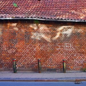 Street scene with old brick wall with light reflection in Copenhagen, Denmark