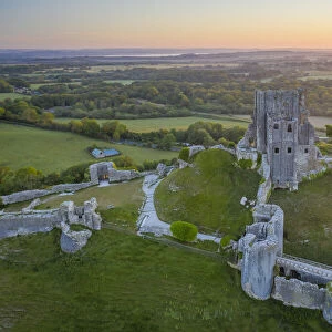 Aerial view of the abandoned ruins of Corfe Castle at dawn, Dorset, England