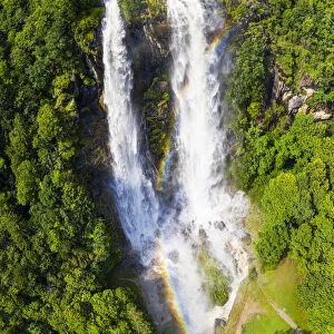 Aerial view of Acquafraggia Waterfall in spring with a rainbow. Valchiavenna, Valtellina