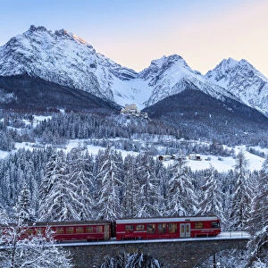 Bernina Express transit on the viaduct in winter. Lower Engadine, Canton of Grisons