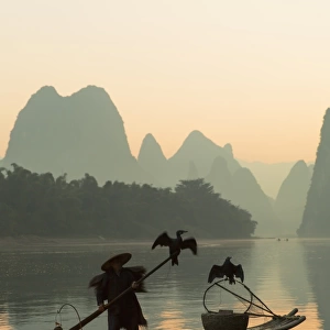 Cormorant fisherman on Li River at dawn, Xingping, Yangshuo, Guangxi, China