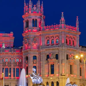 Cybele Palace or Palacio de Cibeles city hall illuminated by colors of Spanish flag