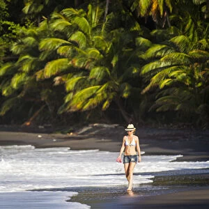 Dominica, Hampstead. A woman walks along No 1 Beach. (MR)